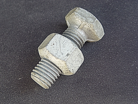 HEAVY INDUSTRIAL BOLT. MEASURMENTS HEAD: 1 1/4 INCHES DIAMETER. LENGTH: 2 5/8 INCHES. 
