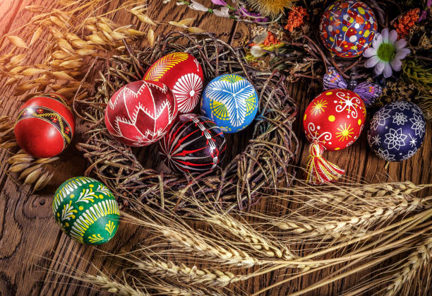 istock colored Easter eggs with wheat ears on the wooden background. Easter themed. Easter symbol. 656438784