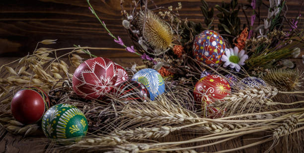 istock colored Easter eggs with wheat ears on the wooden background. Easter themed. Easter symbol. 656438794