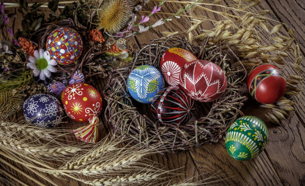 istock colored Easter eggs with wheat ears on the wooden background. Easter themed. Easter symbol. 656438796