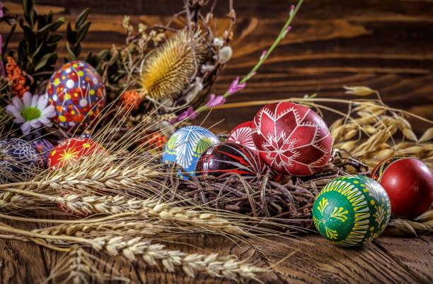 istock colored Easter eggs with wheat ears on the wooden background. Easter themed. Easter symbol. 656441218