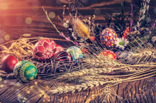 istock colored Easter eggs with wheat ears on the wooden background. Easter themed. Easter symbol. 656441344