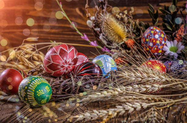 istock colored Easter eggs with wheat ears on the wooden background. Easter themed. Easter symbol. 656441574
