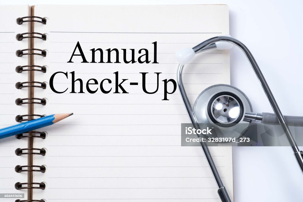 Stethoscope on notebook and pencil with Annual Check-Up words as medical concept. Annual Event Stock Photo