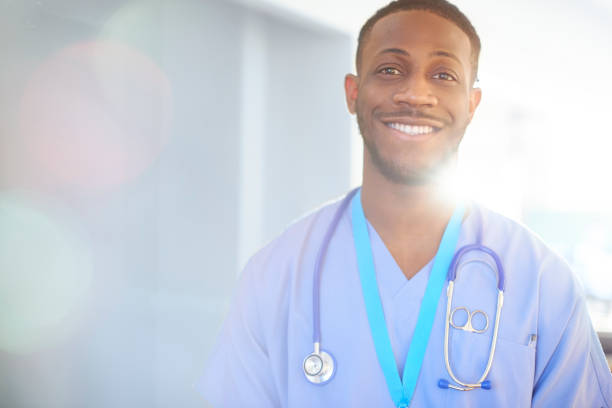 istock Smiling junior doctor in blue scrubs 656441872