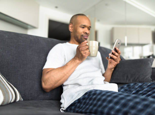 istock man listening music on the couch 656441908
