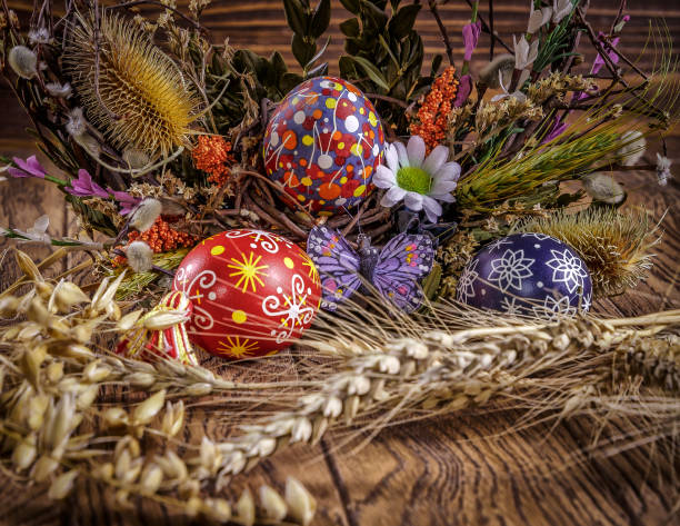 istock colored Easter eggs with wheat ears on the wooden background. Easter themed. Easter symbol. 656441968