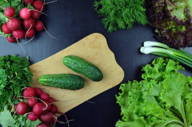 istock Cucumbers and fresh vegetables on a cutting board. 656444264