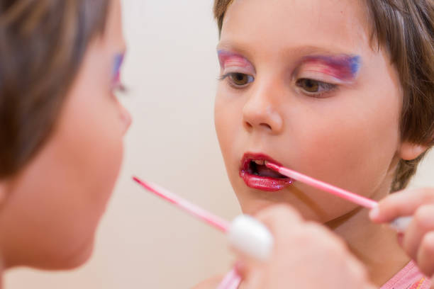 istock Beautiful little girl with lipstck 656447050