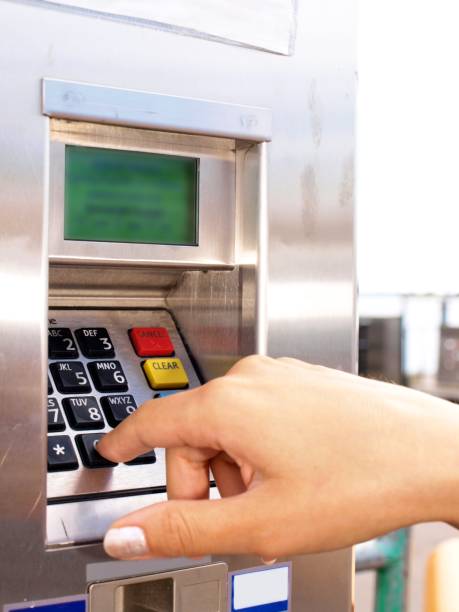 istock Woman entering PIN on a ticket vending machine 656455348