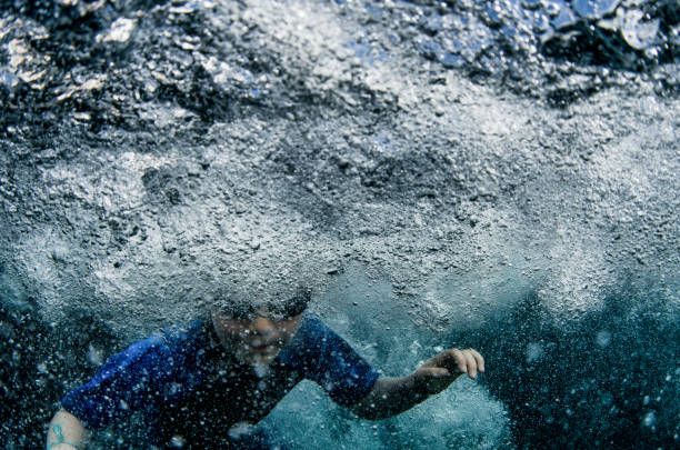 istock Child jumping into ocean to swim underwater 656464320