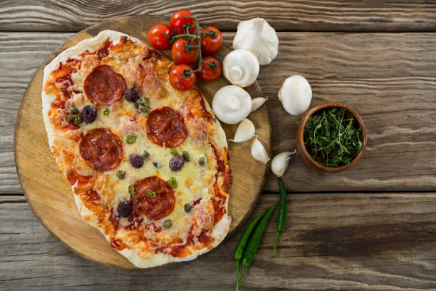 istock Various species with pizza and tomato on a wooden tray 656464362