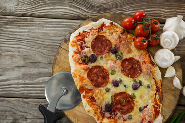 istock Various species with pizza and tomato on a wooden tray 656465552