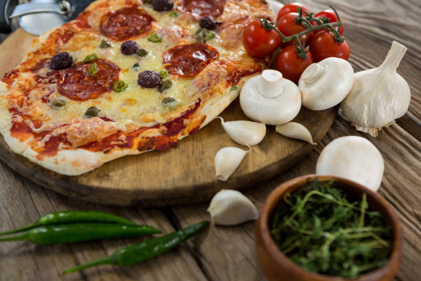 istock Various species with pizza and tomato on a wooden tray 656466440