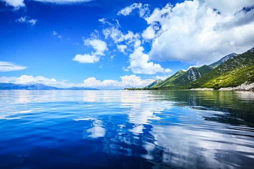 Idyllic seascape - Island, crystal clear Adriatic Sea and Blue Sky with White Clouds