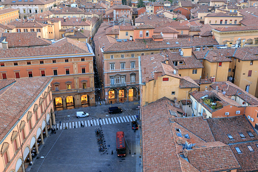 Elevated view of the Piazza Galvani and the Via Farini at dusk in Bologna, Italy.