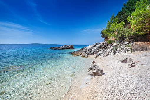 Beach, crystal clear water in Adriatic Sea and Green Mountains