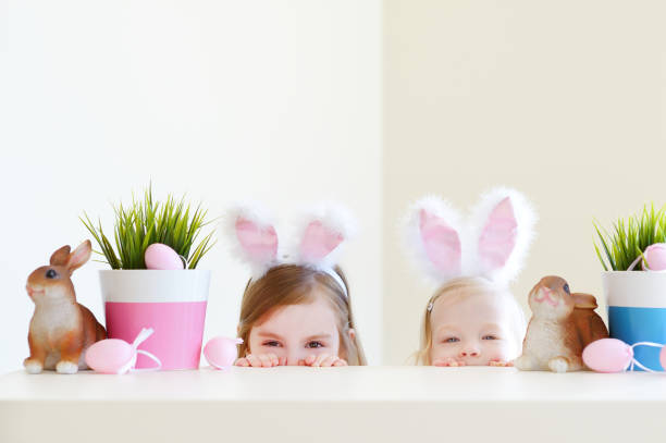 istock Two adorable sisters wearing bunny ears on Easter day 656479374
