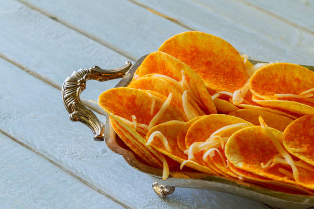istock Natural potato chips heap the bowl on wood background 656483268