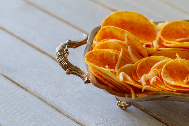 istock Potato chips in bowl and fresh potato 656483384