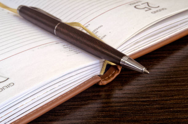 istock Close up of a pen and notebook. 656483772