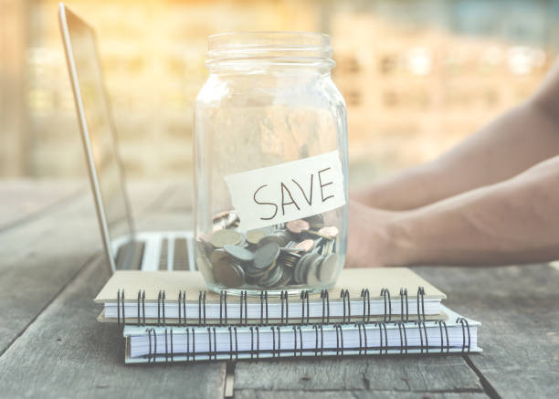 money for saving in glass jar stock photo