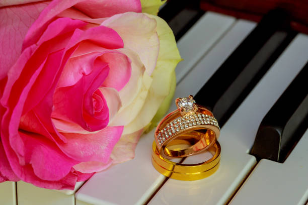 istock Wedding Rings on a piano keyboard and Flowers 656490464