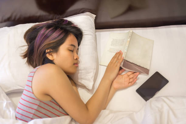 istock Falling asleep with a book on hand in bed 656490522