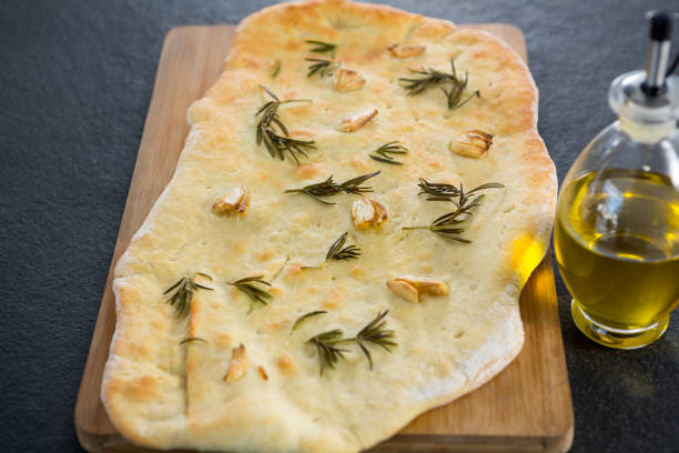 istock Italian pizza with olive oil on a chopping board 656493560