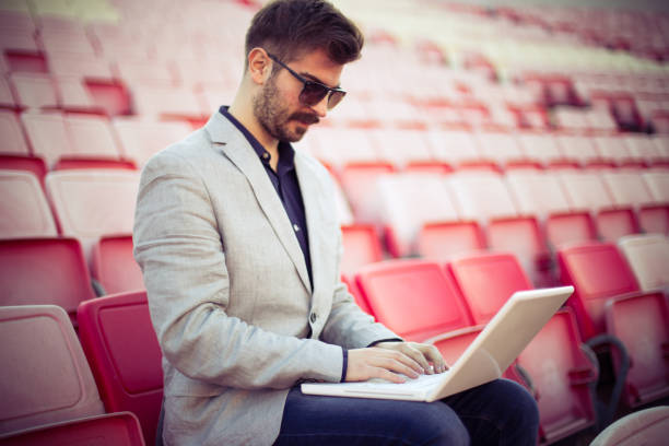 istock Young businessman sitting on tribune and using laptop 656500390