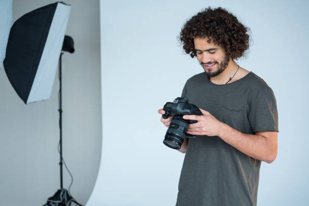 istock Photographer looking at captured photos in his digital camera 656500824