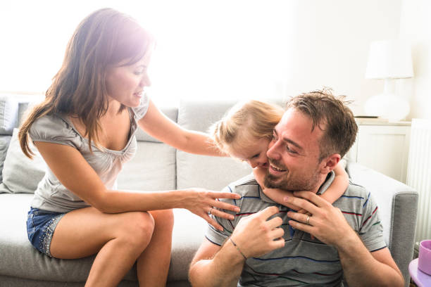 istock little kid playing with the puppet and the parents 656500830