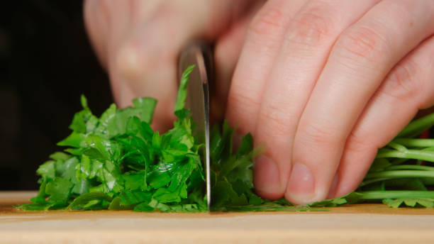 istock Cook cuts a parsley on a cutting board in a kitchen 656504546
