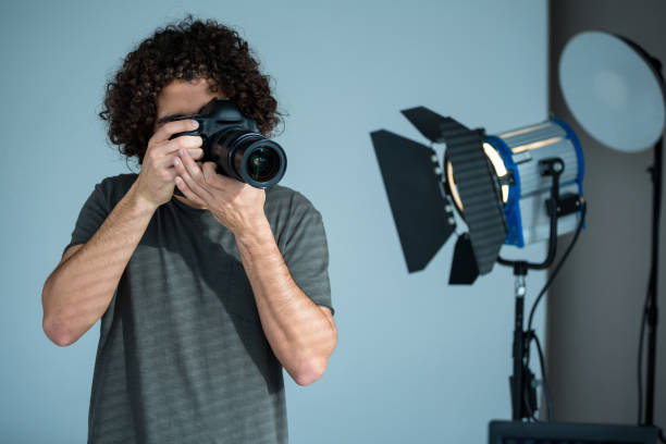 istock Male photographer with digital camera in studio 656505858