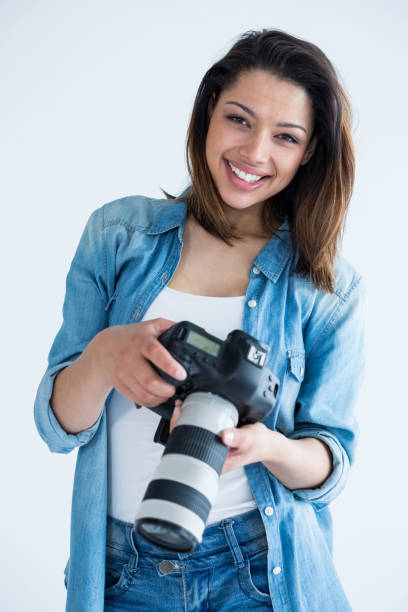 istock Happy female photographer standing in studio 656508644