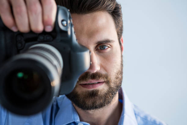 istock Male photographer with digital camera in studio 656511012
