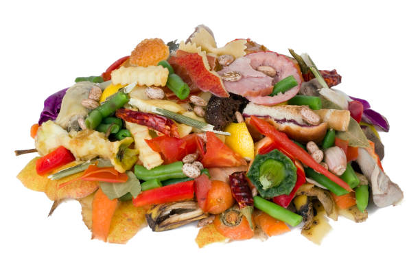 On a white table lies a heap of rotten food waste closeup concept stock photo