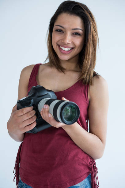 istock Happy female photographer standing in studio 656511322