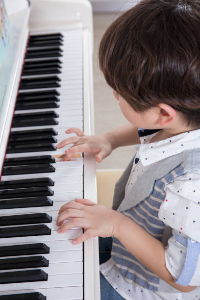 istock Asian Chinese little boy playing piano at home 656514574