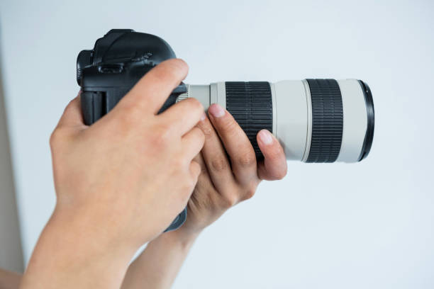 istock Close-up of photographer holding digital camera 656514906