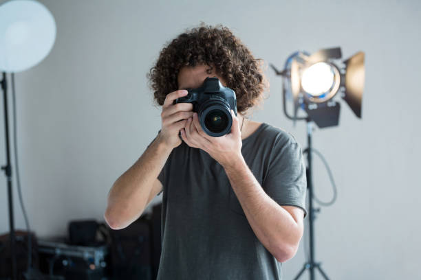 istock Male photographer with digital camera in studio 656515134
