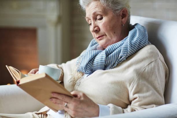 istock Pretty senior woman reading book 656516166