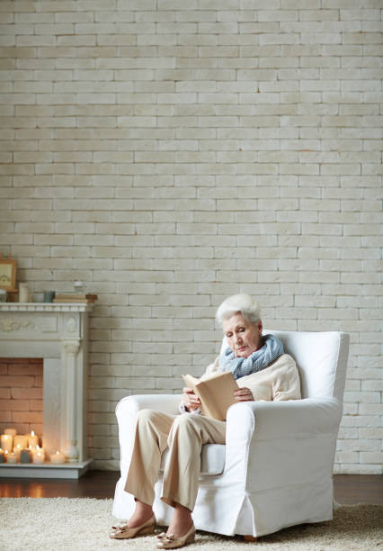 istock Elderly woman wrapped up in reading 656516176
