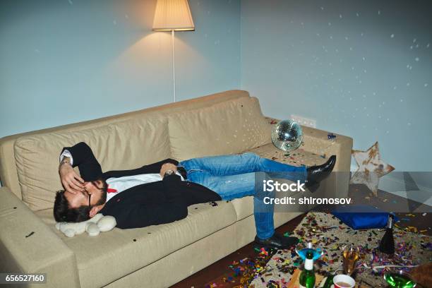 Asian Man Having Hangover After Party Stock Photo - Download Image Now - Flooring, Drunk, Lying Down