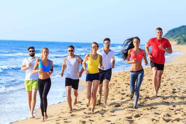 istock Group of sportmen jogging on beach 656527366
