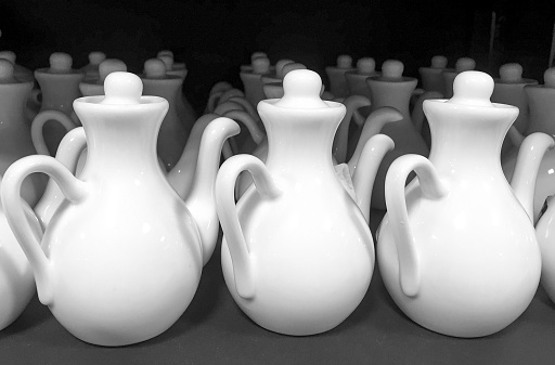 Rows of white ceramic jugs on display at store