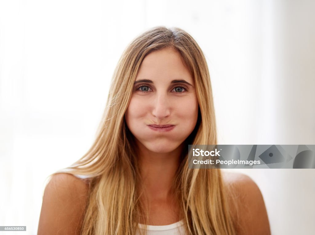 Thirty seconds closer to healthy gums Portrait of a young woman rinsing her mouth with mouthwash at home Mouthwash Stock Photo