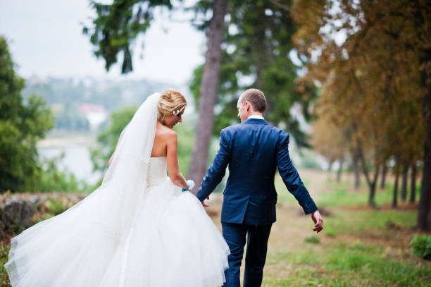 istock Married walking in the rain at park 656531762