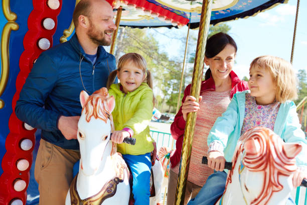 istock Pretty family having fun on carousel 656534838