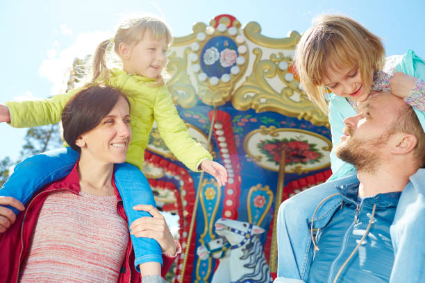 istock Family enjoying sunny day in funfair 656534862